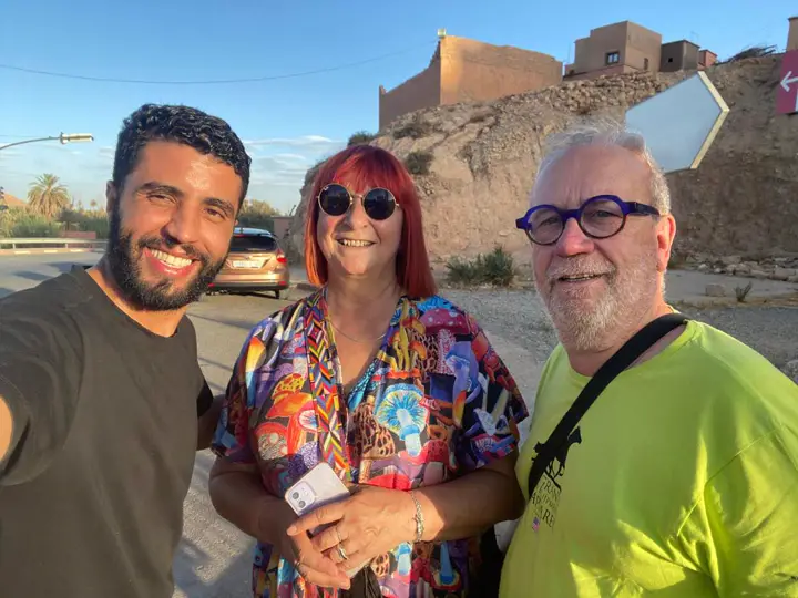 Our team with two guests in front of a kasbah